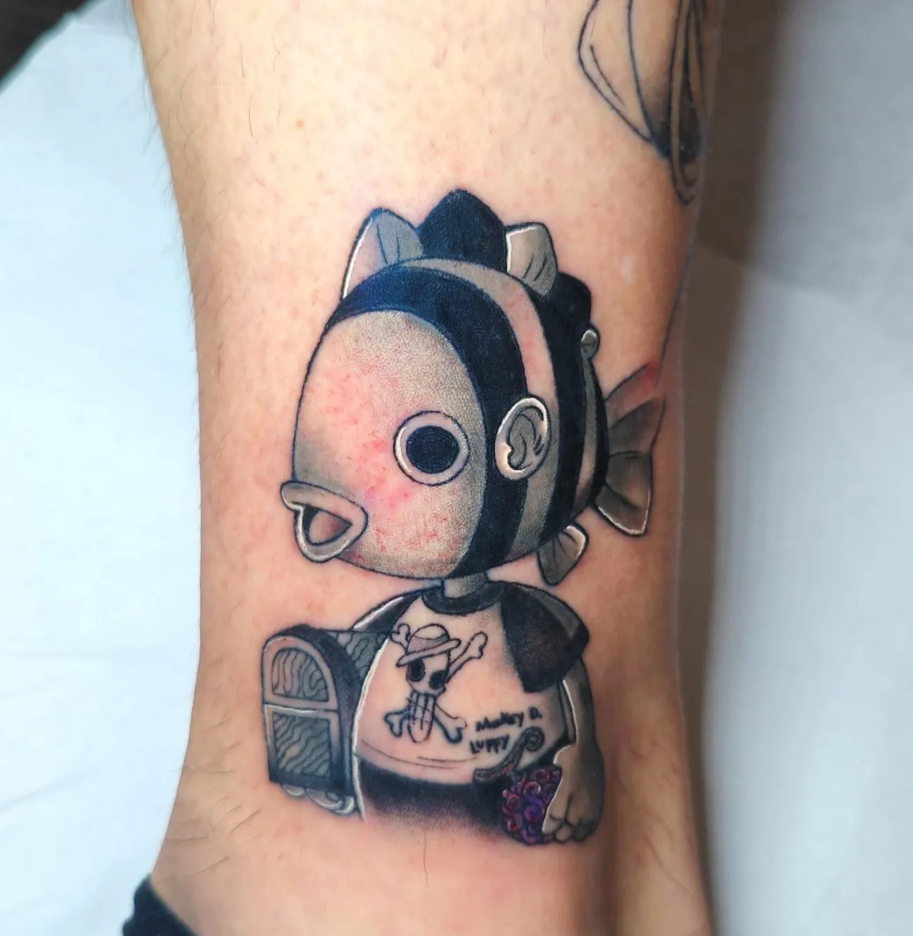 Tatuaje anime de pez con camiseta de Monkey D. Luffy
